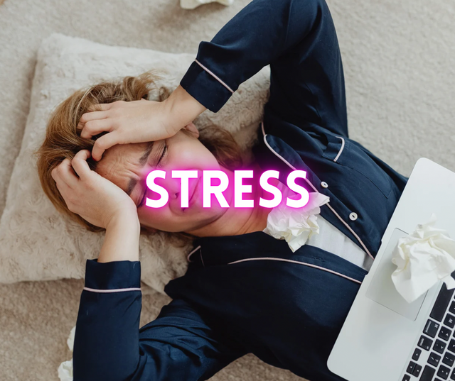 Woman lying down holding her head in distress, with the word STRESS