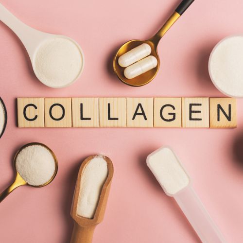 Collagen powder in spoons around wooden letter tiles spelling COLLAGEN