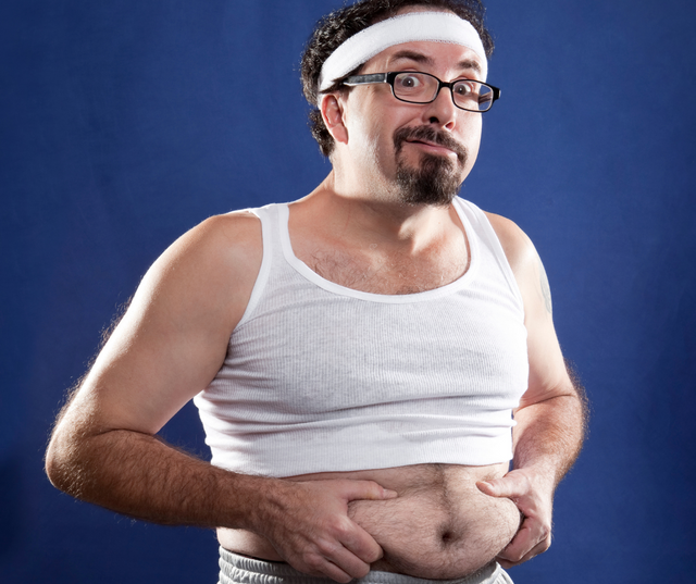 Man in a vest lifting his top to show belly fat