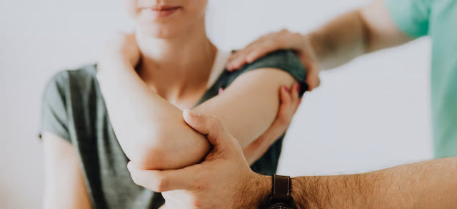 Physiotherapist examining a woman's shoulder