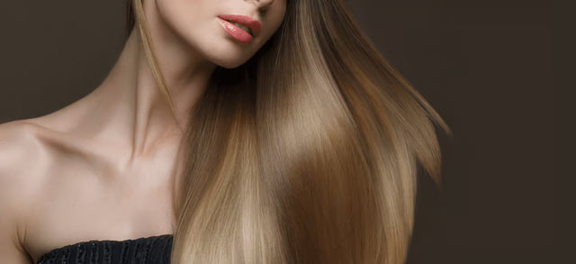 Woman with long straight blonde hair against a dark background